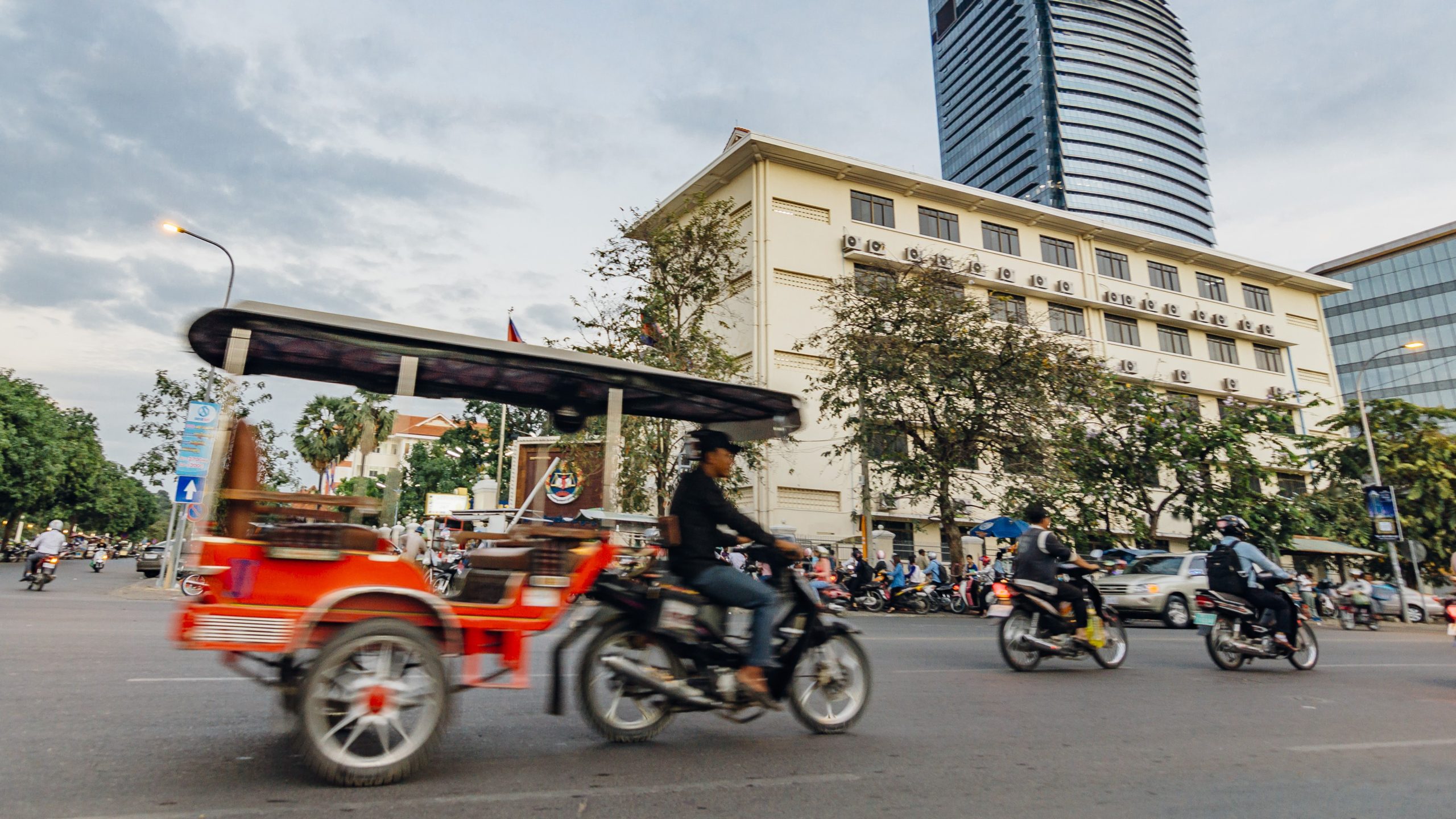 People driving motorbikes on the street in Phnom Penh, Cambodia